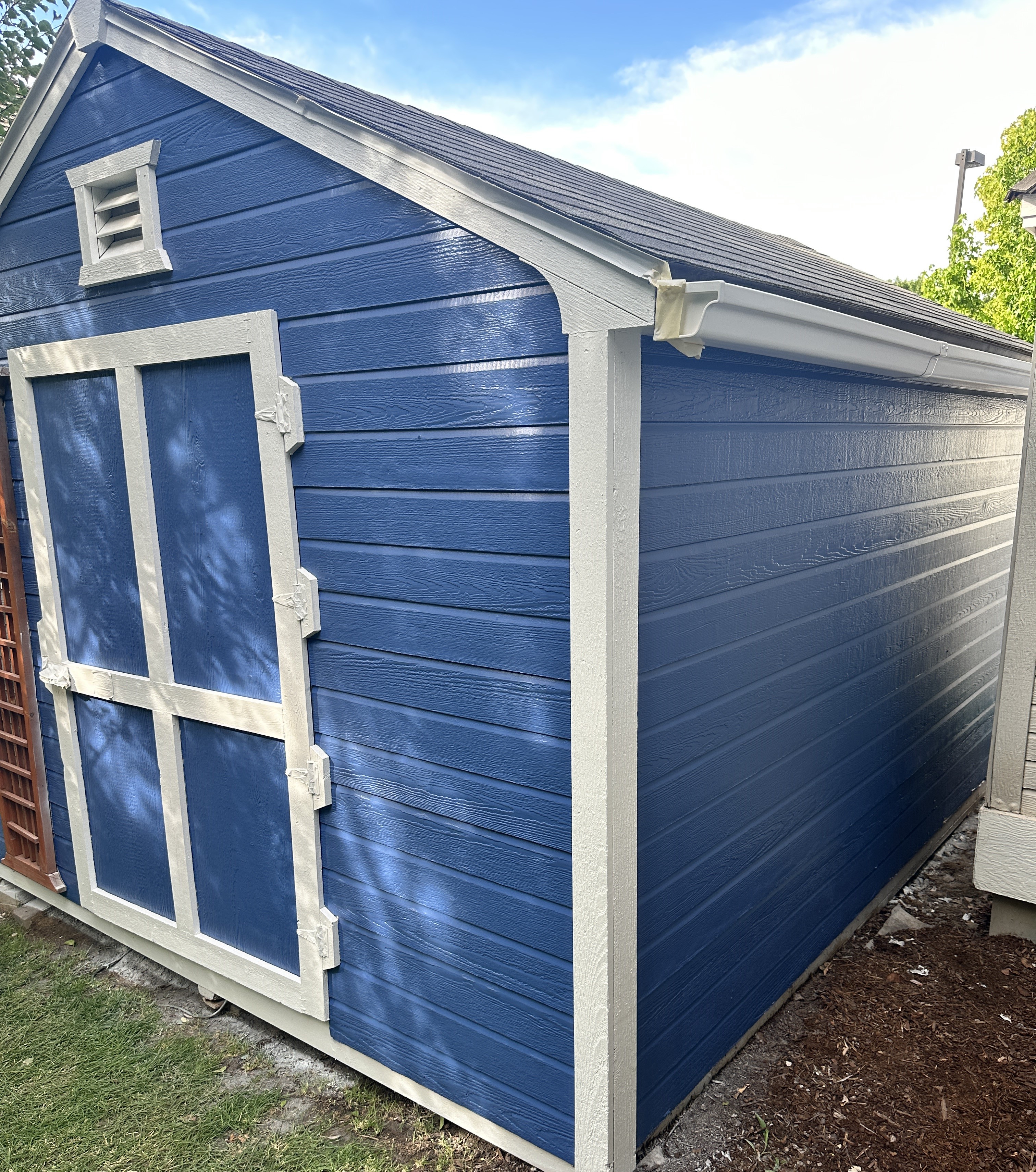 shed painted blue with white trim